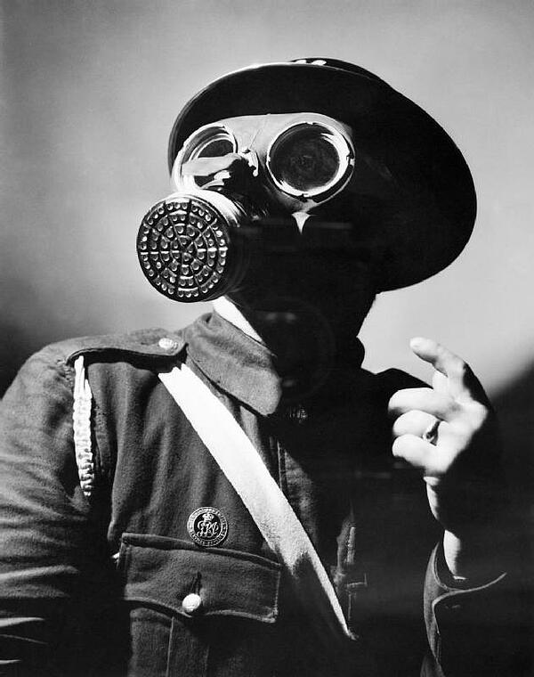 An Air Raid Warning wearing a gas mask