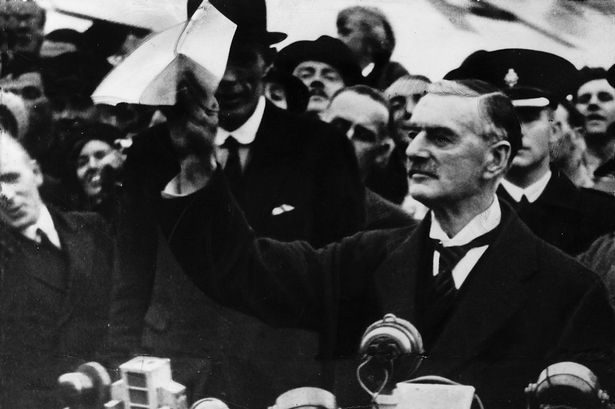 Neville_Chamberlain_declares_peace_in_our_time_after_returning_from_Munich_with_his_piece_of_paper_after_seeing_Hitler.jpg
